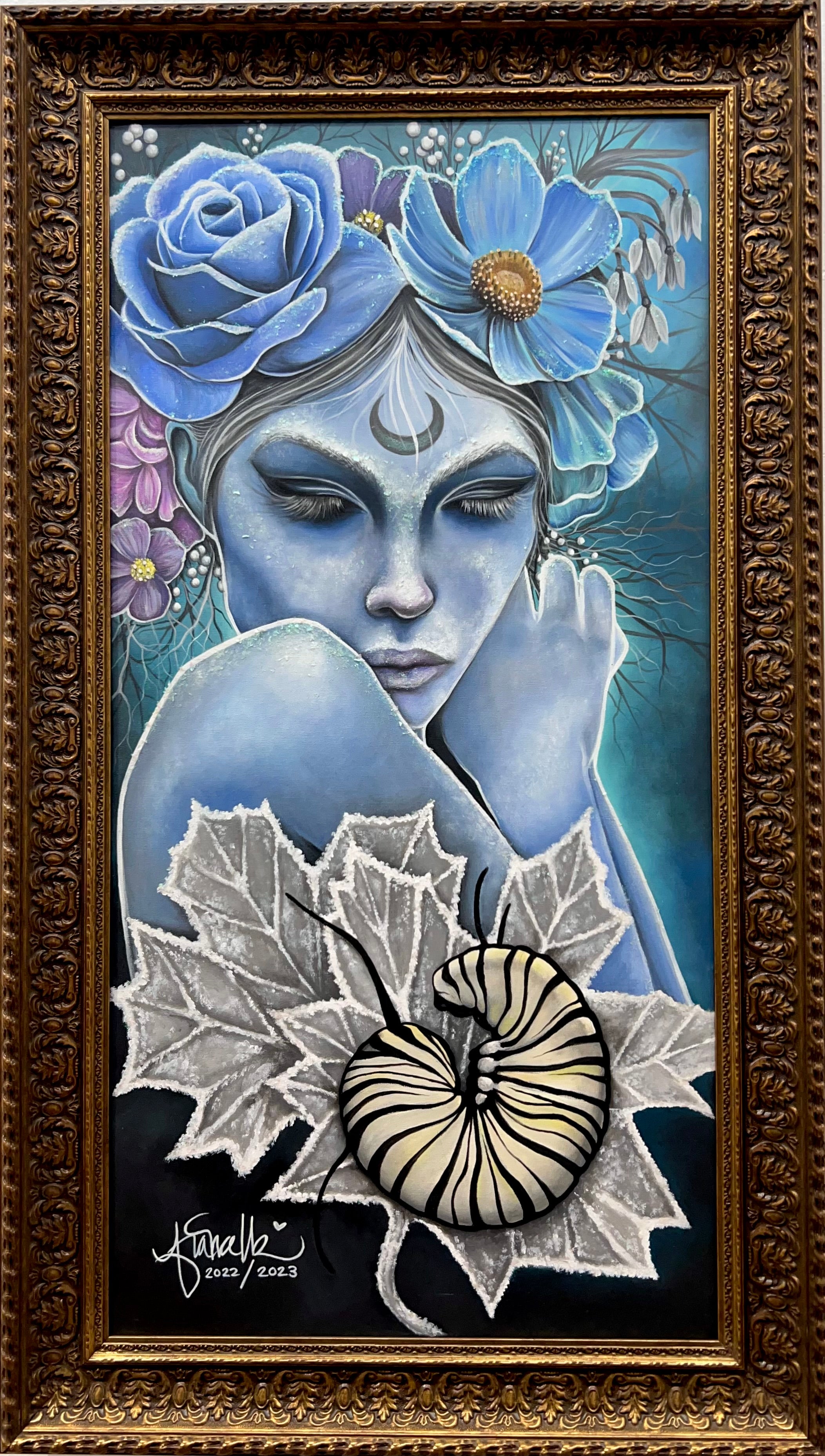 Artistic depiction of a woman with blue hair and flowers, surrounded by nature elements, in a decorative frame.